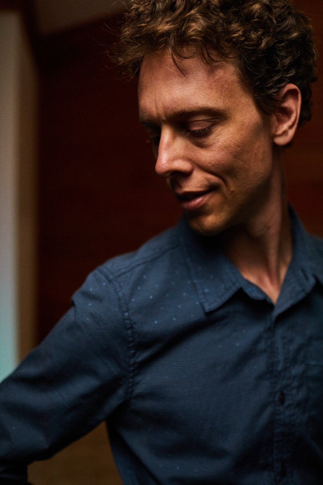 Mark Andreas, contemplative, in soft natural light.